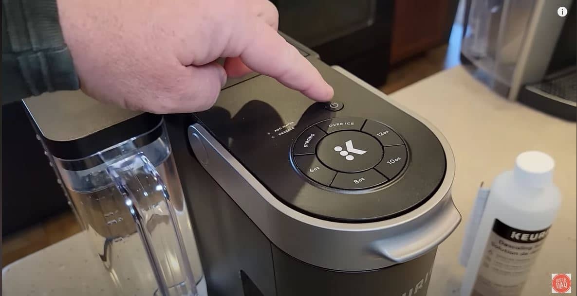 keurig power button being pressed