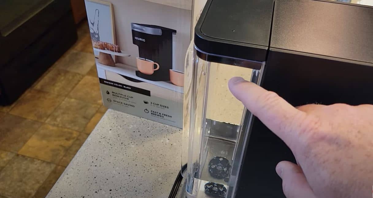 finger pointing to keurig water reservoir