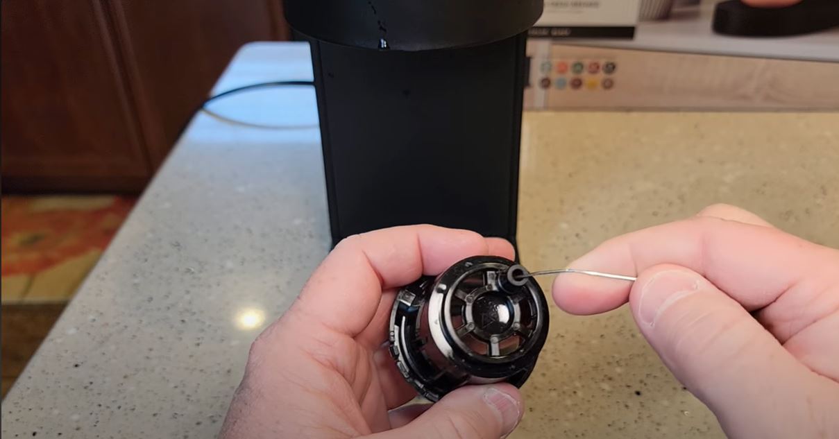 inserting paper clip into keurig k slim basket